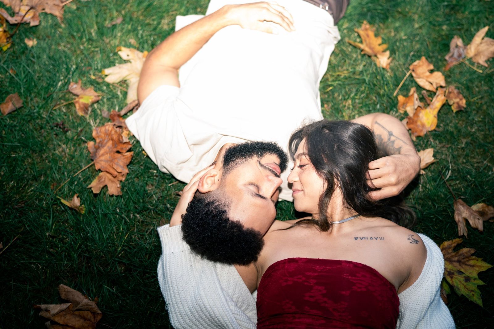 Couple lying in autumn leaves