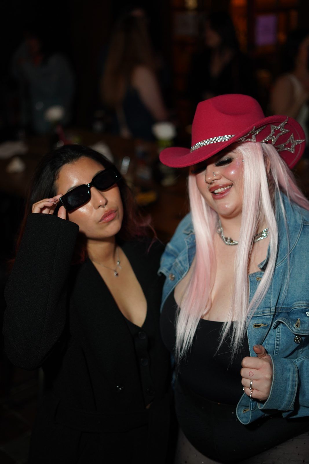Two friends posing at a night event